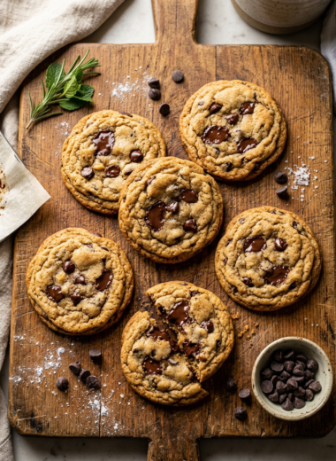 Golden brown chocolate chip cookies with crispy edges and soft centers on wooden board